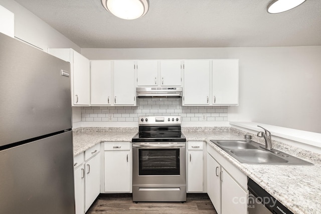 kitchen with tasteful backsplash, dark hardwood / wood-style floors, sink, stainless steel appliances, and white cabinets