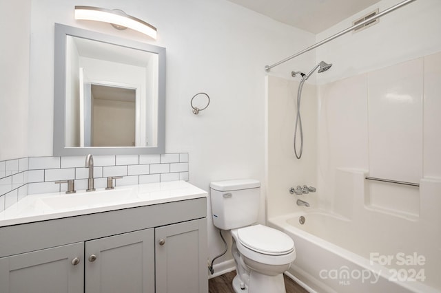 full bathroom featuring toilet, tasteful backsplash, vanity, and bathtub / shower combination