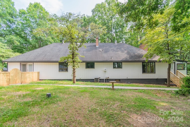 rear view of house with a lawn