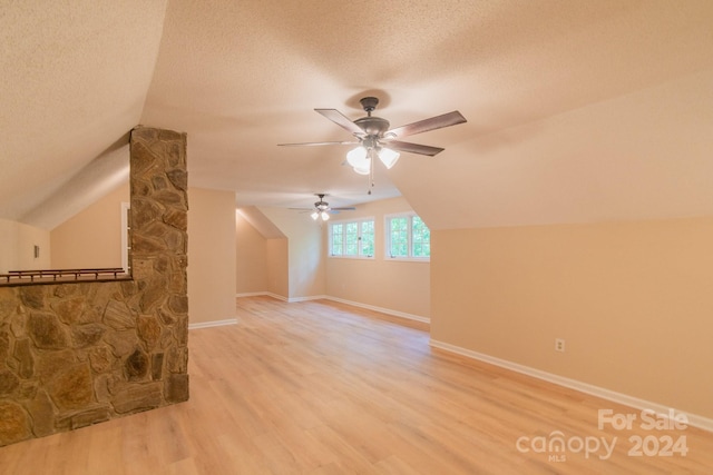 bonus room featuring a textured ceiling, ceiling fan, lofted ceiling, and hardwood / wood-style floors