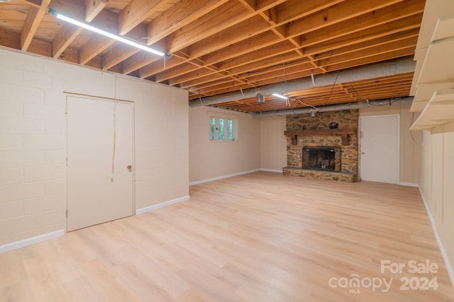 basement with a fireplace and hardwood / wood-style flooring