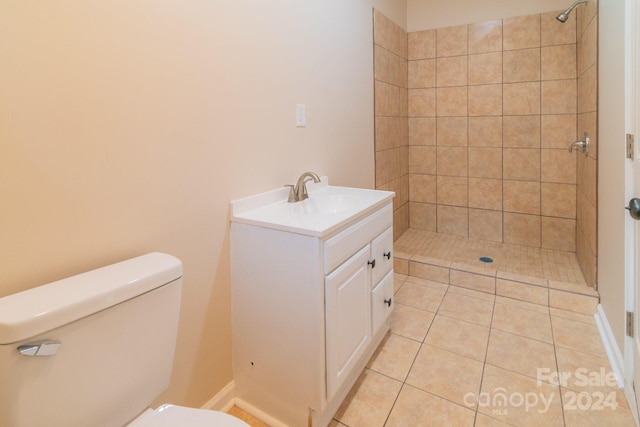 bathroom featuring toilet, tile patterned floors, and a tile shower