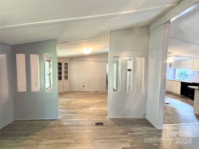 interior space with hardwood / wood-style floors and lofted ceiling