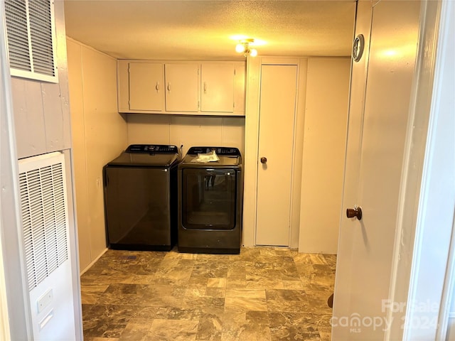 laundry area featuring cabinets and washer and dryer