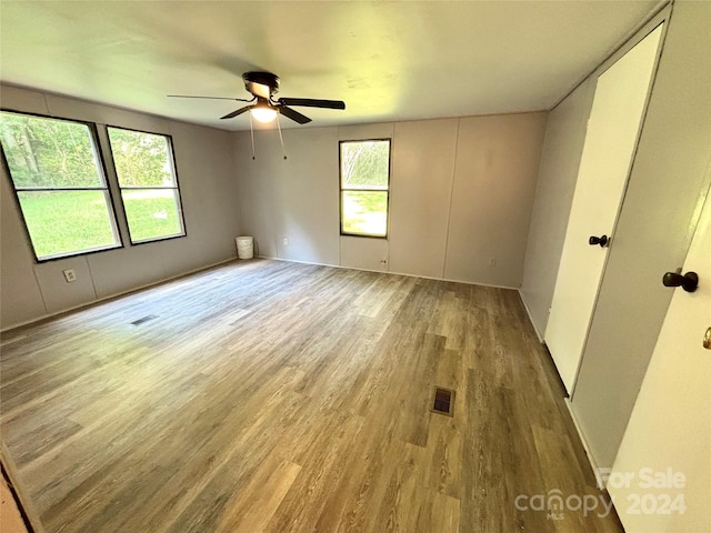 empty room featuring hardwood / wood-style floors and ceiling fan