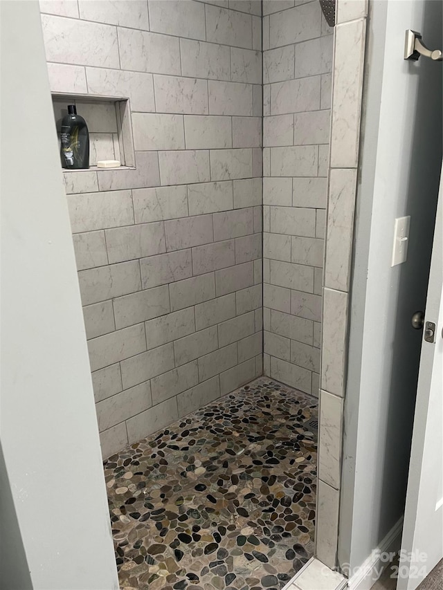 bathroom with a tile shower