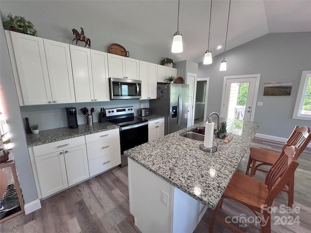 kitchen featuring white cabinetry, stainless steel appliances, a center island with sink, and sink