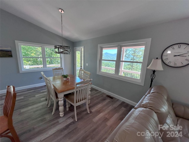 dining area with dark wood-type flooring, a wealth of natural light, and vaulted ceiling