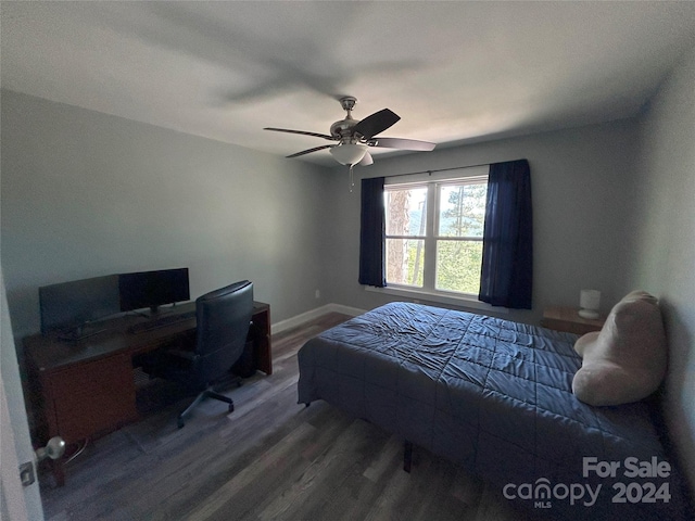 bedroom with ceiling fan and dark wood-type flooring