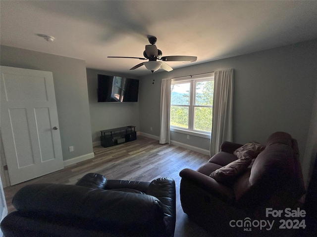 living room with ceiling fan and wood-type flooring