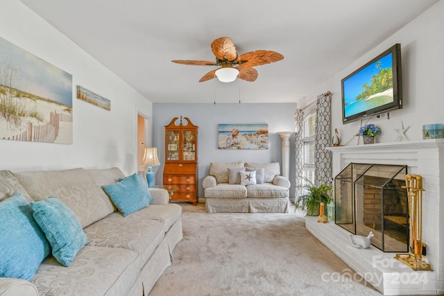 living room with ceiling fan, light colored carpet, ornate columns, and a fireplace