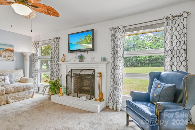 living room with ceiling fan, carpet flooring, a fireplace, and plenty of natural light