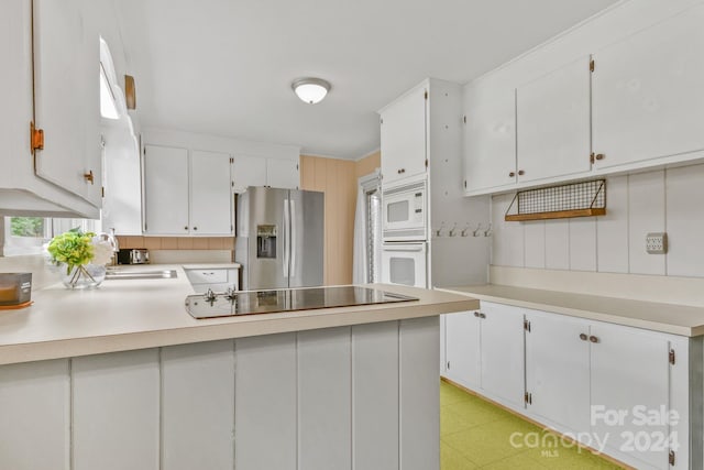 kitchen featuring crown molding, sink, white cabinets, and white appliances