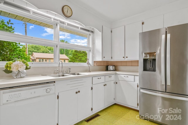 kitchen with stainless steel refrigerator with ice dispenser, sink, white dishwasher, and white cabinetry