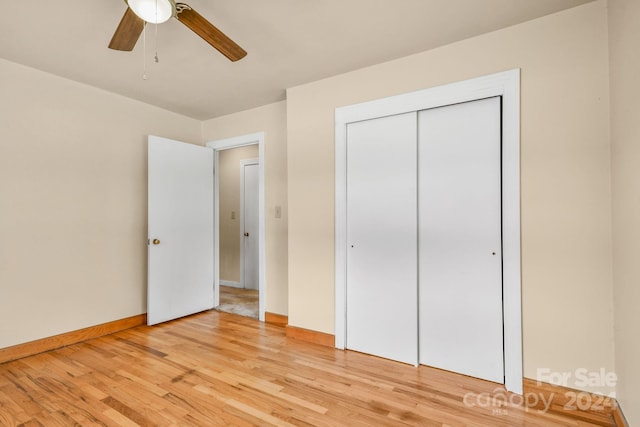 unfurnished bedroom with ceiling fan, a closet, and light hardwood / wood-style flooring