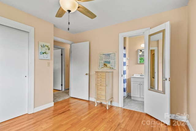 unfurnished bedroom featuring ceiling fan, light hardwood / wood-style floors, and ensuite bathroom