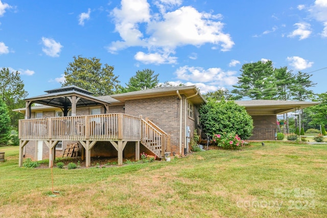 back of property with a wooden deck and a lawn