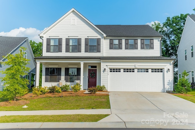 view of front of house featuring a front lawn and a garage