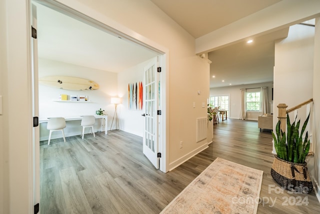 corridor with hardwood / wood-style flooring