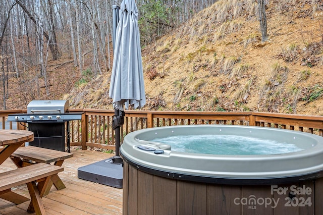 wooden terrace with a hot tub and a grill