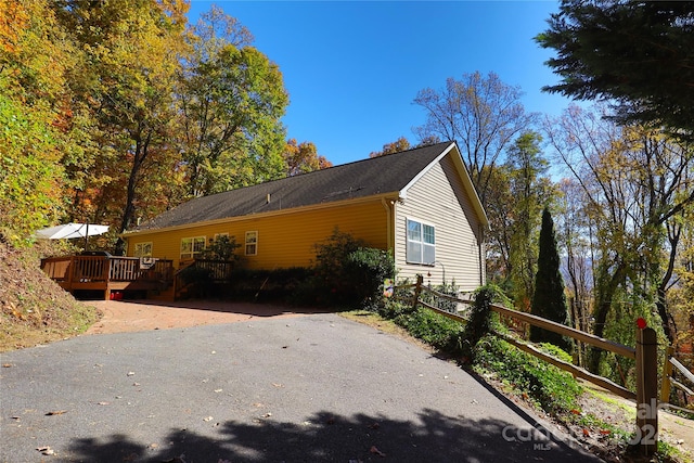 view of side of home featuring a wooden deck