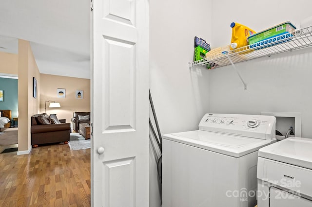 laundry area featuring light hardwood / wood-style floors and washer and clothes dryer