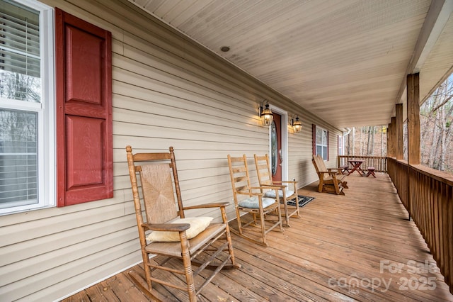 wooden terrace featuring covered porch