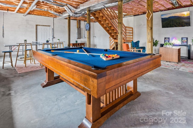 rec room with billiards, concrete flooring, and electric panel