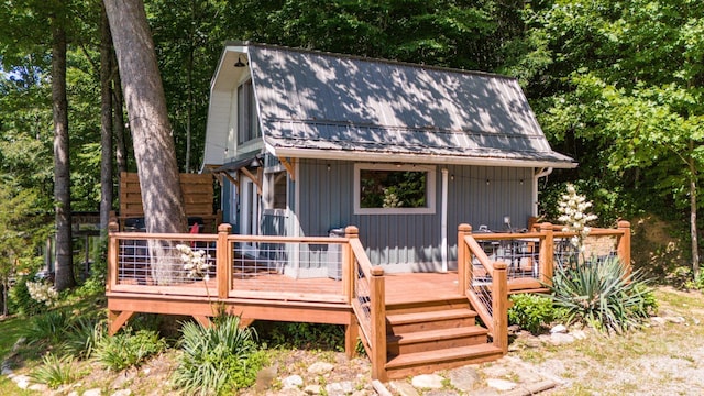 back of property featuring a wooden deck