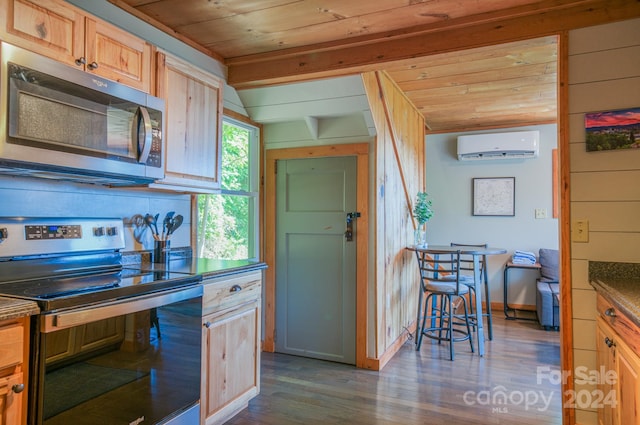 kitchen featuring dark hardwood / wood-style floors, a wall unit AC, wooden walls, appliances with stainless steel finishes, and wood ceiling