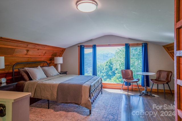 bedroom with vaulted ceiling and hardwood / wood-style floors