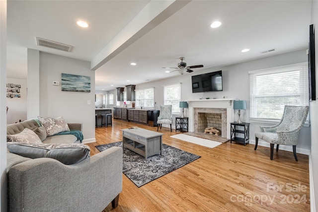 living room with ceiling fan and light wood-type flooring