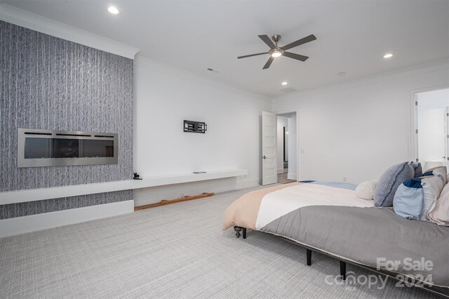 carpeted bedroom featuring crown molding and ceiling fan