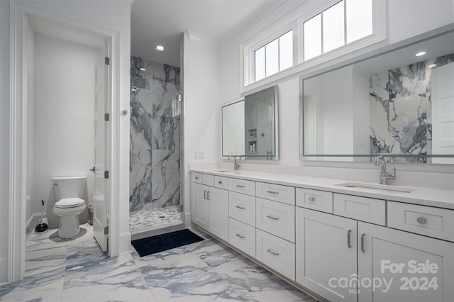 bathroom with vanity, tiled shower, ornamental molding, and toilet