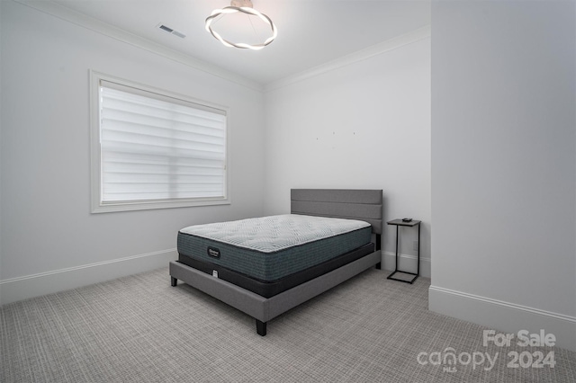 bedroom featuring carpet flooring and ornamental molding