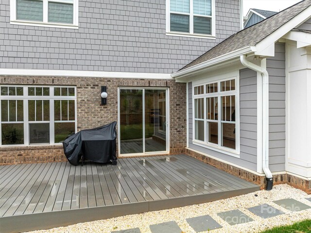 wooden terrace with a grill