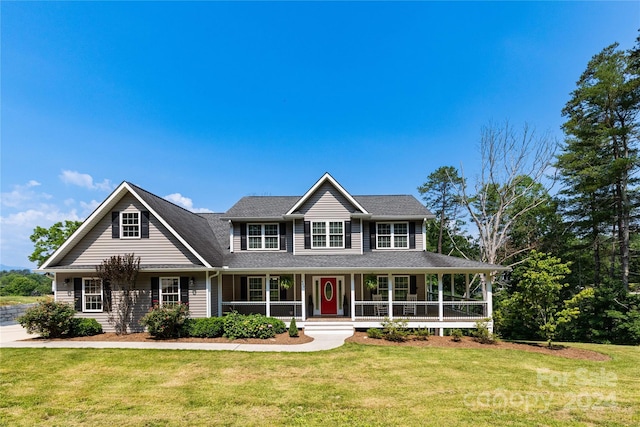 view of front of home featuring covered porch and a front lawn