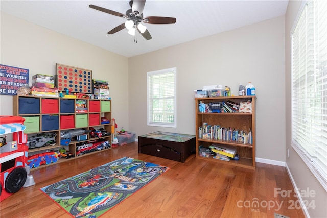 game room with hardwood / wood-style flooring and ceiling fan