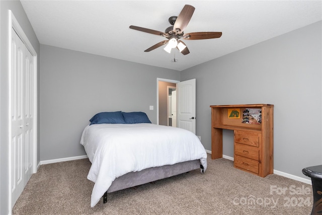 carpeted bedroom with ceiling fan and a closet