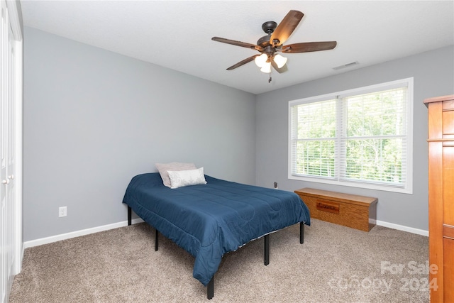 bedroom featuring light colored carpet and ceiling fan