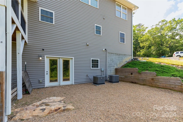 rear view of property with central AC unit