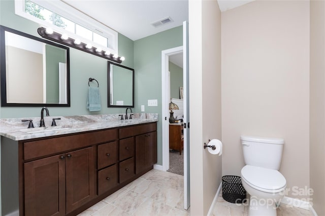 460 Panther Branch Rd, Alexander, NC 28701 - bathroom with double vanity, baseboards, toilet, and marble look tile flooring