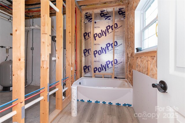 460 Panther Branch Rd, Alexander, NC 28701 - bathroom with wood finished floors and a bath
