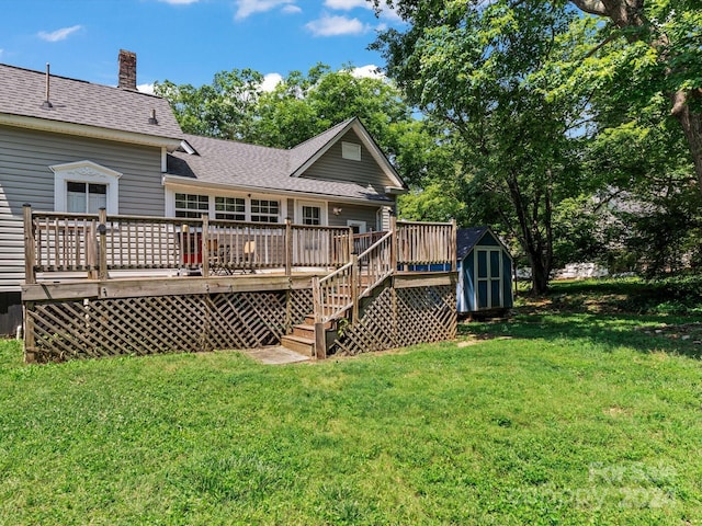 back of property featuring a lawn, a storage unit, and a deck