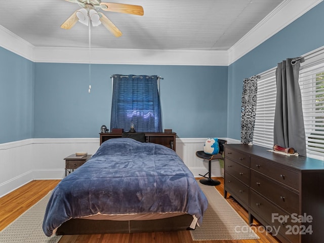 bedroom with ceiling fan, ornamental molding, and hardwood / wood-style flooring