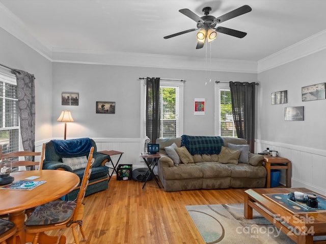 living room featuring light wood-type flooring, ceiling fan, and crown molding