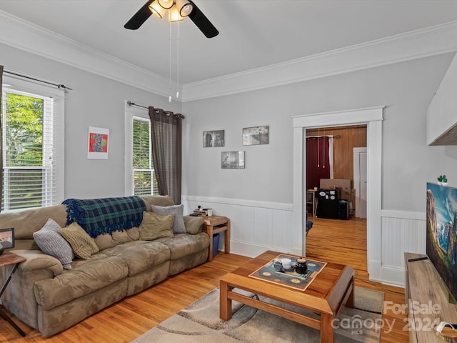 living room with ceiling fan, hardwood / wood-style floors, and ornamental molding