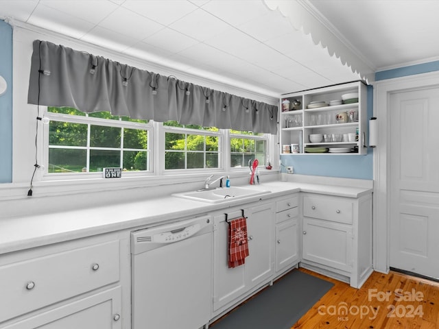 kitchen with white dishwasher, white cabinets, sink, ornamental molding, and light hardwood / wood-style floors