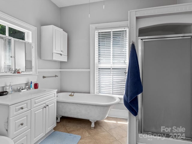 bathroom with vanity, tile patterned floors, a wealth of natural light, and separate shower and tub