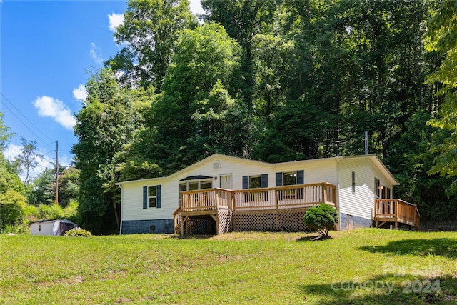 view of front of house with a wooden deck and a front yard